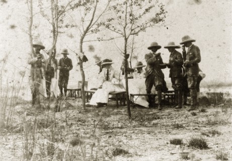 Hunting party lunch. A hunting party comprised of British men and women takes a midday break to eat