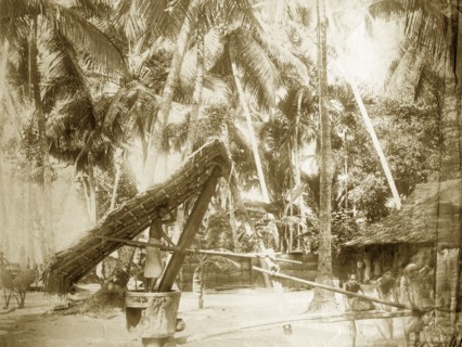Burmese grinding mill. A team of children work together to operate a large grinding mill in a rural
