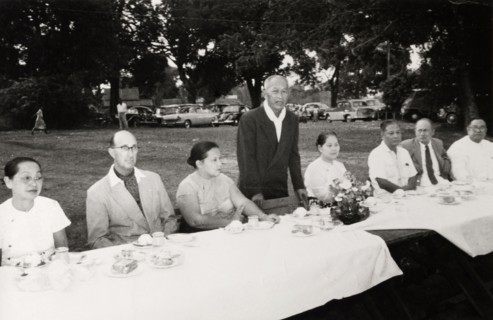Speech at Rangoon Golf Club. A Burmese man stands to deliver a speech for an audience at the