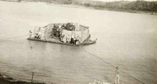 Transporting elephants across a river. Two elephants, used to manoeuvre timber in the teak forests