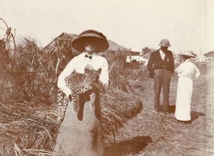 A formidable beast. A European woman wearing a large sun hat holds an Indian Leopard cub (Panthera