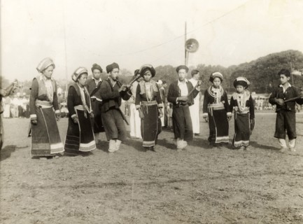 Burmese musicians. A party of Burmese musical performers in traditional dress perform at an outdoor