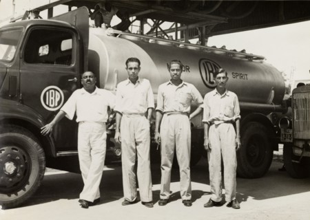 Indo-Burma Petroleum Company tanker. Four uniformed Burmese workers pose for a photograph in front