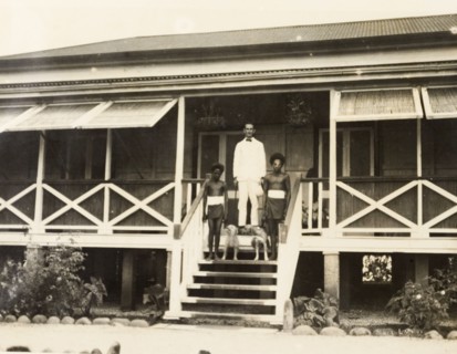 Clifford Francis and his domestic servants. A European District Officer, Clifford Francis, poses