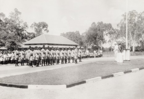 Addressing a regiment of the King's African Rifles. Two European men address a regiment of the