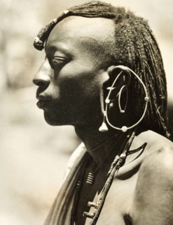 African man with a distinctive earring. Profile shot of the head and shoulders of a young African