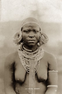 Kikuyu woman. Half-length portrait of a semi-naked Kikuyu woman wearing neck chains and heavy