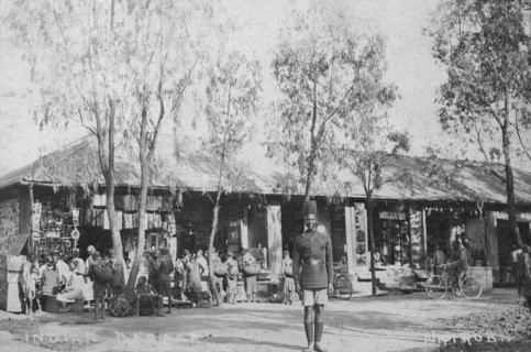 Indian market. A policeman pictured at an Indian market in front of a range of single-storey shops