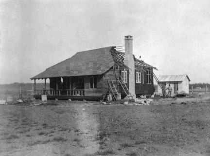 Building a house. This is the third in a series of four photographs showing the rapid erection of a