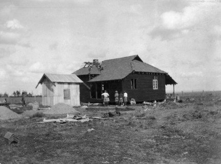 Building a house. This is the last in a series of four photographs showing the rapid erection of a