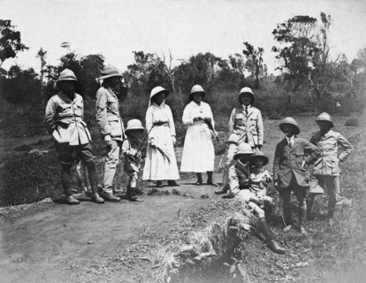 Europeans on an outing. A party of European men, women and children wearing pith hats pose for the