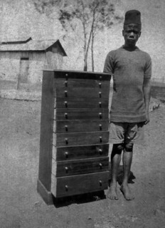 African cabinetmaker. An employee of the Public Works Department, identified in the the caption as