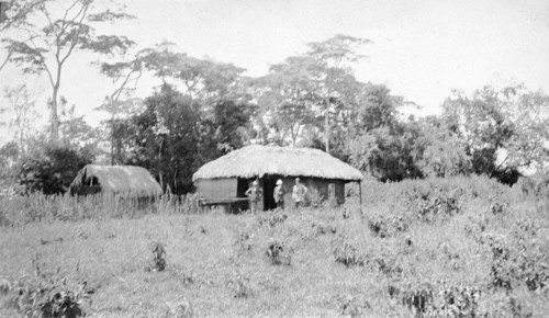 European settler's home. Three men pictured outside a European settler's home in rural surroundings