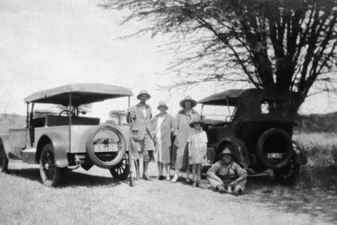 Roadside halt. Informal group portrait of a European family and friends on the roadside between two