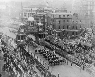 Coronation celebrations for Edward VII. The royal carriage proceeded by mounted soldiers passes