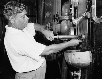 Testing samples at a sugar mill. An Indian worker tests a sample of sugar from an industrial