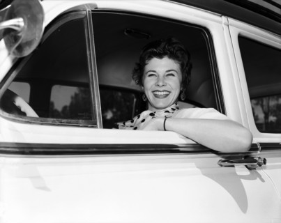 Daphne Dale in the driving seat. Dancer Daphne Dale smiles from the driver's seat of a car. She