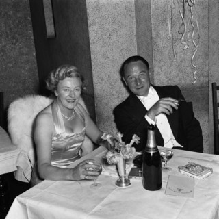 Couple at the SJAK dance. A couple dressed in formal evening wear enjoy a glass of wine at a dance
