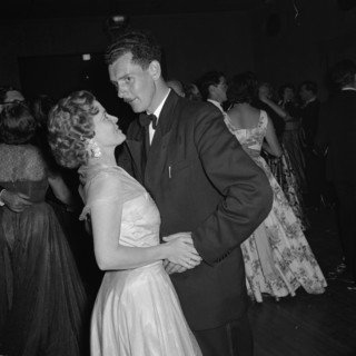On the dancefloor at the SJAK dance. A couple touch hands on the dance floor at an event held for