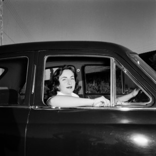 Sue Paton in her MG. Sue Paton smiles from the driver's seat of her MG car, her elbow resting on