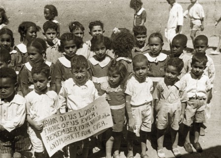 Sudanese schoolchildren. Two boys at the front of a group of African schoolchildren in uniform hold
