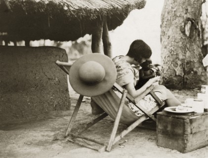 Mollie with Sudanese baby. A European woman captioned as 'Mollie' plays with a Sudanese baby