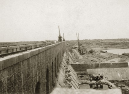 Sennar Dam nearing completion. Cranes and earthworks on the construction site of the nearly