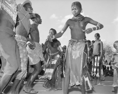 A Turkana 'ngoma'. A group of Turkana adults dance at a crowded 'ngoma'. They wear traditional