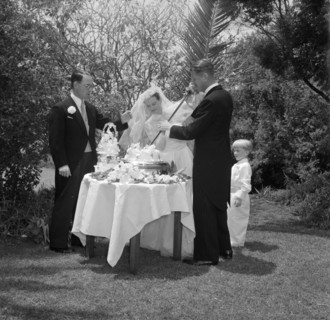 Cutting the cake with a ceremonial sword. The newlywed Williams and McLaughlin couple cut their