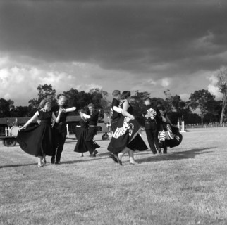Square dancing at the SJAK show. Four couples wearing matching dance costumes perform a square