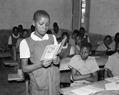 Reading out loud. Promotional shot for the East African Literature Bureau. An African schoolgirl