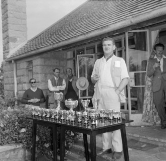 Prize-giving speech. Eric Mathers gives a speech, cigarette in hand, at the prize-giving ceremony