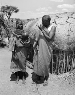 Lesanguniguni and his wife. A Samburu man identified as 'Lesanguriguri' chats to his young wife who