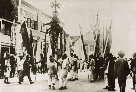 Chinese New Year procession. Banners and flags are paraded through town in celebration of the