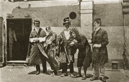 Comedians aboard HMS Hood. A group of comedians aboard HMS Hood dressed in a variety of character