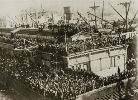 Leaving party. Hoards of people crowd together on every available ledge to wave goodbye to the