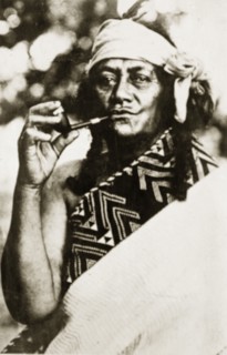 Portrait of a Maori wahine. Portrait of a Maori wahine (woman) wrapped in a patterned blanket,