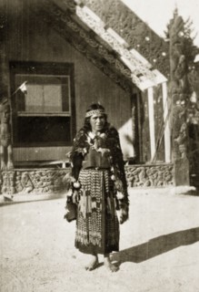 Portrait of a Maori guide. Portrait of a Maori guide outside an elaborately carved building.
