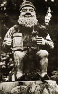 Elf in the sunken gardens. An model elf, flowers and tankard in hand, at Butchart gardens.