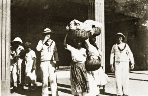 Jamaican street scene. Uniformed sailors from the British Special Service Squadron pose for the