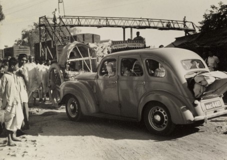 Journey to a dak bungalow. "David and Marjorie's car with Caroline at the window, held up in a