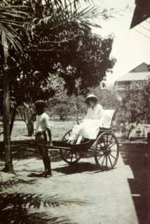 Mrs Tamlin in a taxi. Mrs Dorothy Tamlin takes a ride in a rickshaw taxi. Probably Ghana, circa