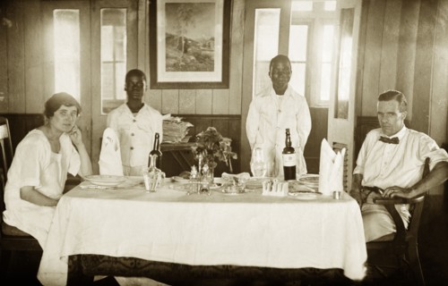 The Tamlins at table. Mr Alfred Tamlin and Mrs Dorothy Tamlin pose for the camera, sitting at a