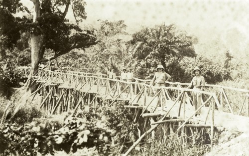 Timber bridge near Accra. Europeans and Africans pose for the camera on a timber bridge near Accra.