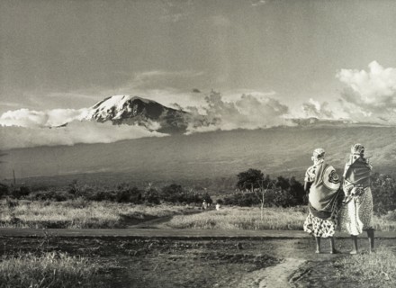 Kilimanjaro skyline. Two African women take in a view of Mount Kilimanjaro. Tanganyika Territory