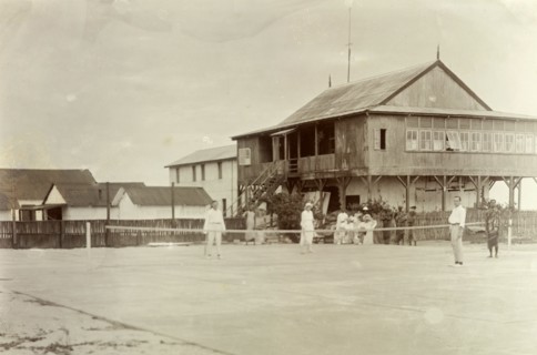 Mr. Tamlin plays tennis. Mr Alfred Tamlin (the European figure on the right) plays tennis with his