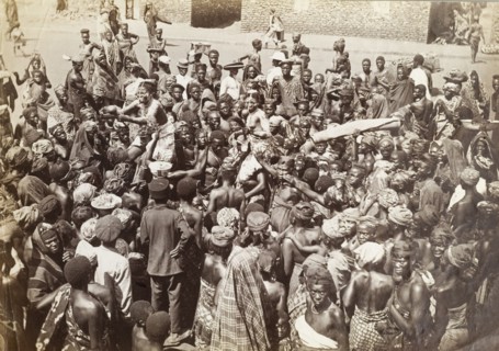 Chief's funeral in Accra. An overhead shot of a mourning party gathered in the street for a