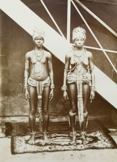 Two women in beaded dress, Gold Coast. Outdoors portrait of two young women wearing elaborate