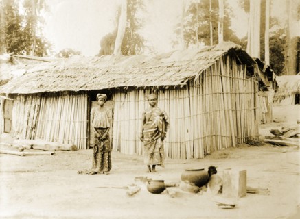 Traditional bush hut, Gold Coast. A traditional bush hut with occupants standing outside. Accra,