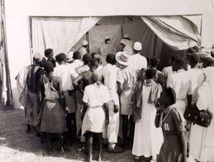 Public health demonstration. Official publicity shot for the Tanganyikan government. A crowd of